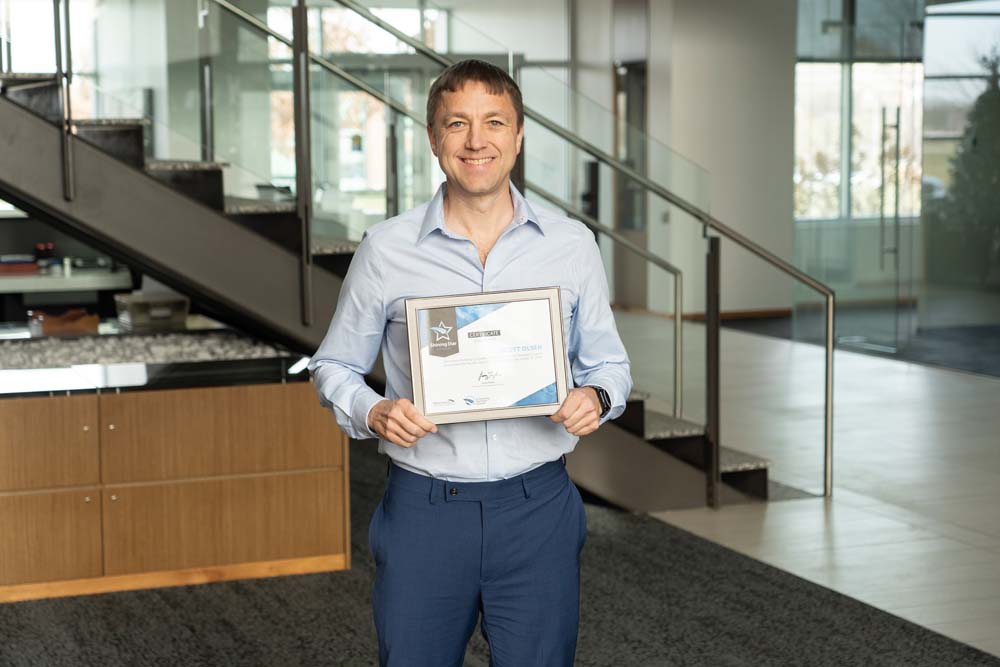 Shining Star runner-up Scott Olsen holding certificate