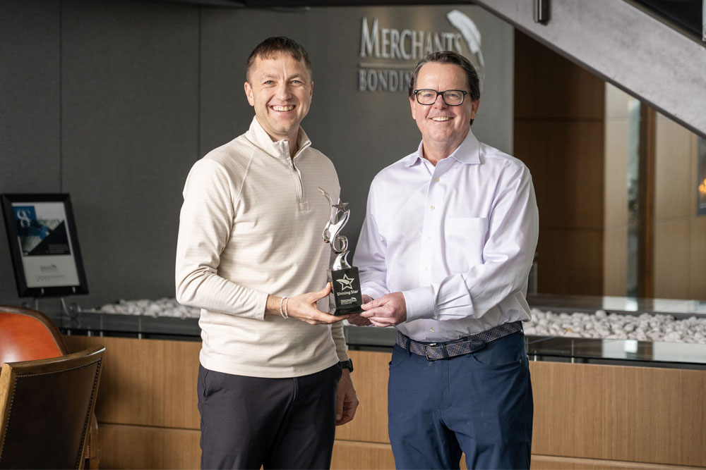 Shining Star winner Scott Olsen holding trophy